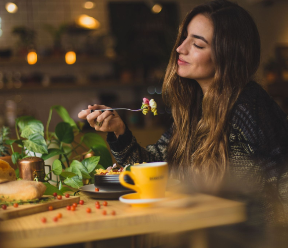 Ayurveda Consultation service image depicting a woman eating healthy foods